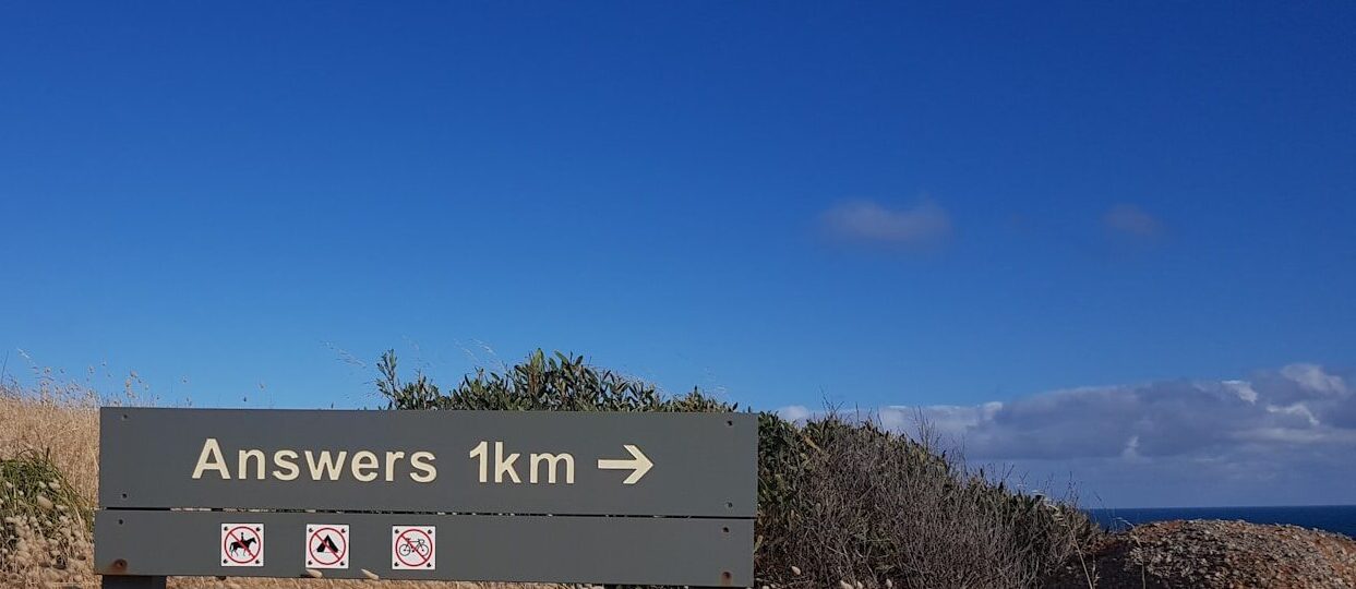 a sign that is on the side of a hill