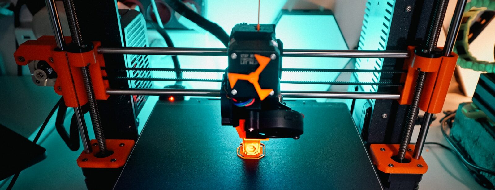 A 3D printer is creating a small object.